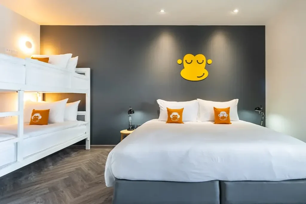 Orangutan With Bathpod room with a main bed and bunk bed at Blu Monkey Hub & Hotel Krabi Town